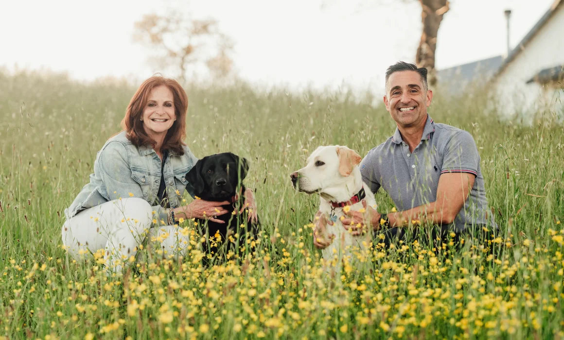 Owners of Domaine de la Rivière with their two dogs