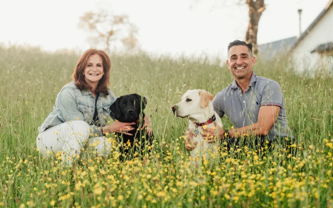 Owners of Domaine de la Rivière with their two dogs